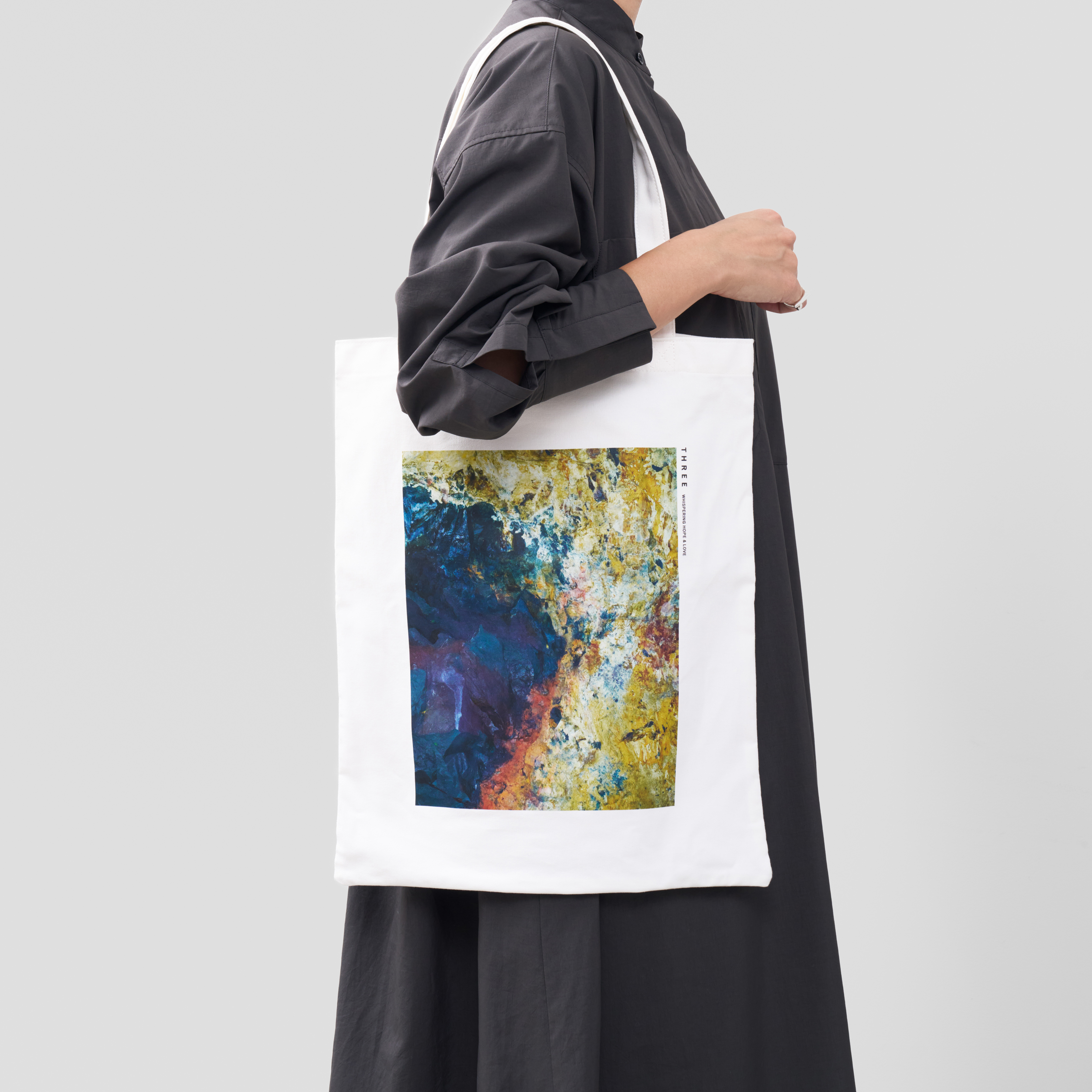 THREE ウィンターギフト ホリデーコレクション 2025 トートバッグを持っている人物